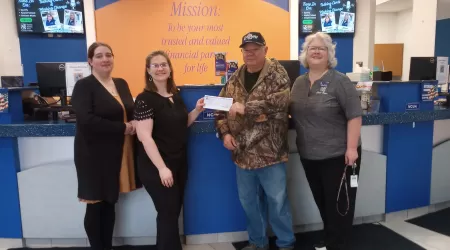AAACU Team members taking a selfie as they clean up trash in their community
